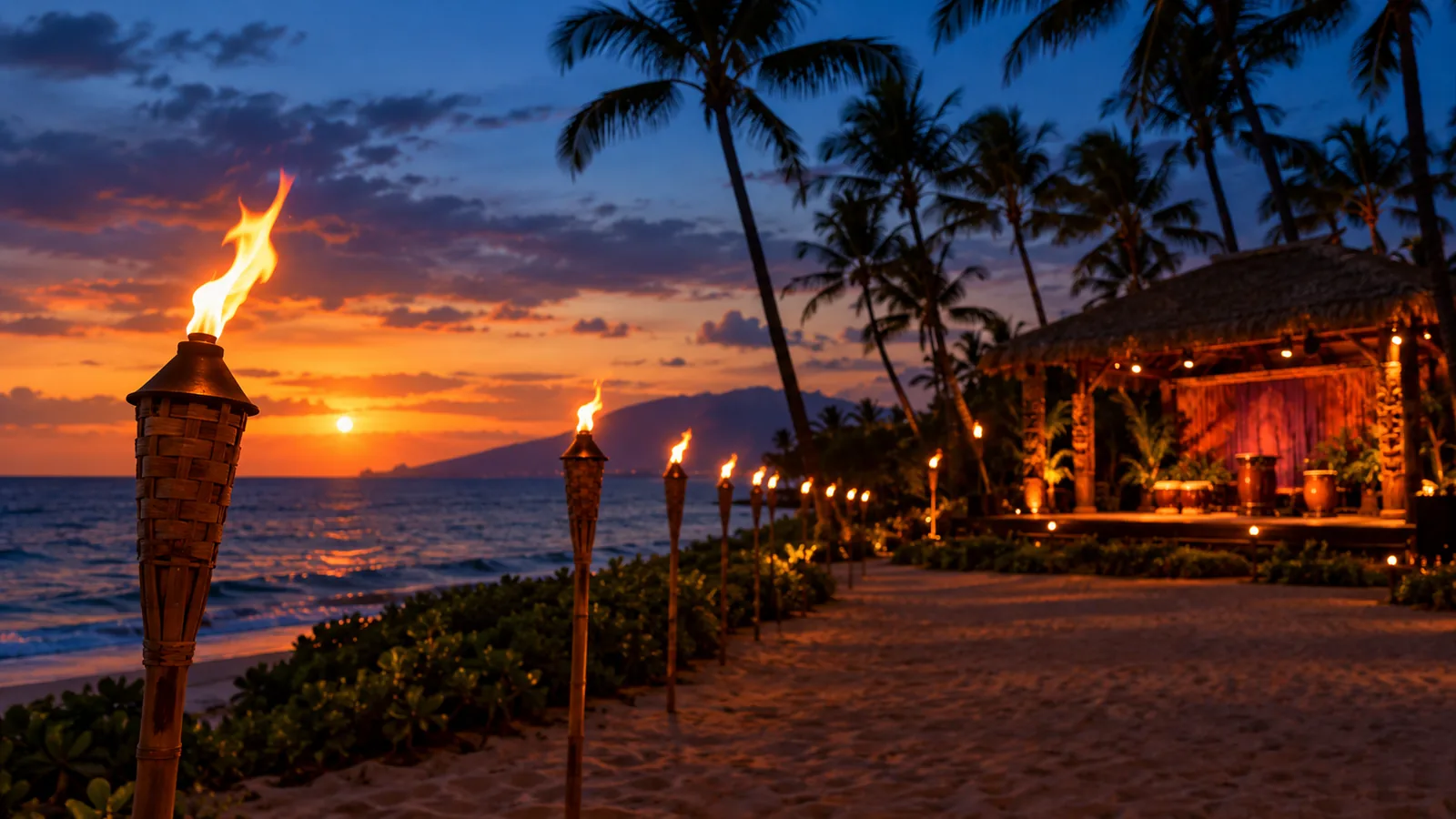 Tiki torches along a Hawaiian beach at blue hour